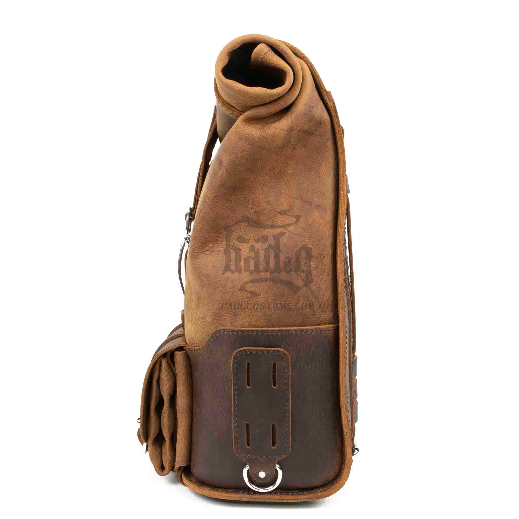 Upgrade your ride with the URB01 Rolltop Backpack Saddlebag. Unique design enables quick conversion from saddlebag to backpack. Hand crafted in USA with premium veg tan water buffalo leather and stainless steel hardware. Durable and stylish, it's the perfect fit for your motorcycle.