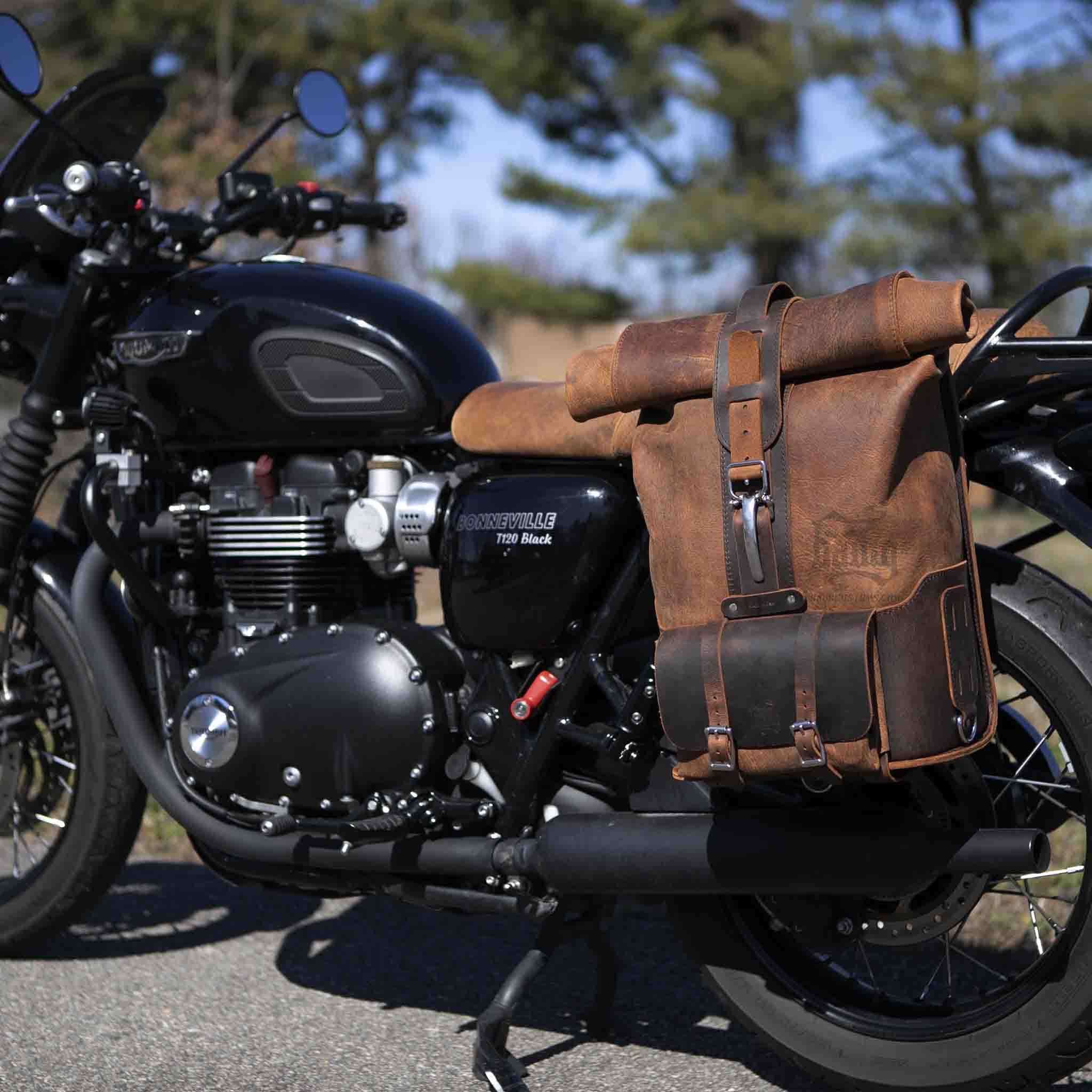 Upgrade your ride with the URB01 Rolltop Backpack Saddlebag. Unique design enables quick conversion from saddlebag to backpack. Hand crafted in USA with premium veg tan water buffalo leather and stainless steel hardware. Durable and stylish, it's the perfect fit for your motorcycle.