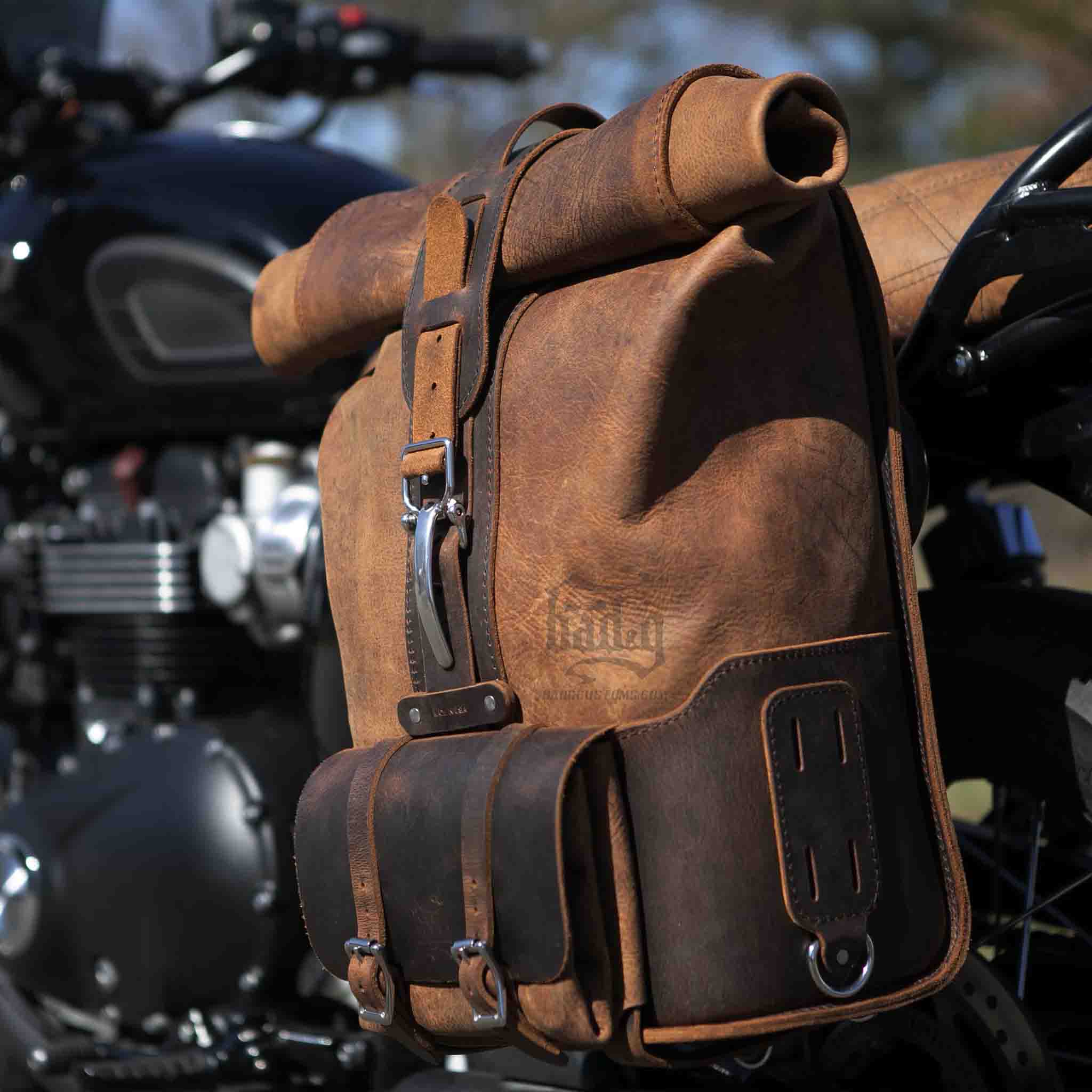 Upgrade your ride with the URB01 Rolltop Backpack Saddlebag. Unique design enables quick conversion from saddlebag to backpack. Hand crafted in USA with premium veg tan water buffalo leather and stainless steel hardware. Durable and stylish, it's the perfect fit for your motorcycle.